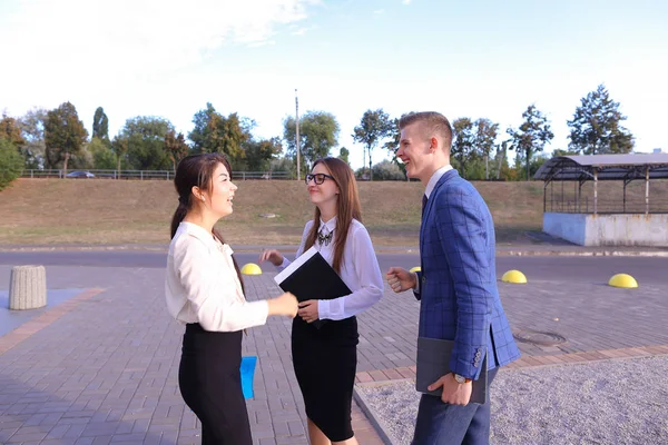 Three young successful businessman, students communicate, smilin