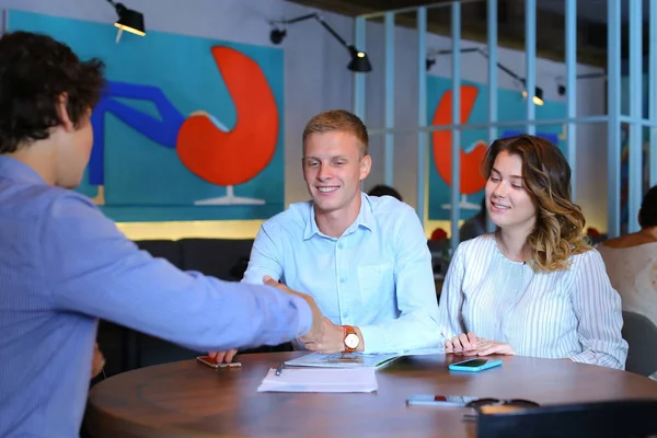 Young couple buy apartment with realtor contract