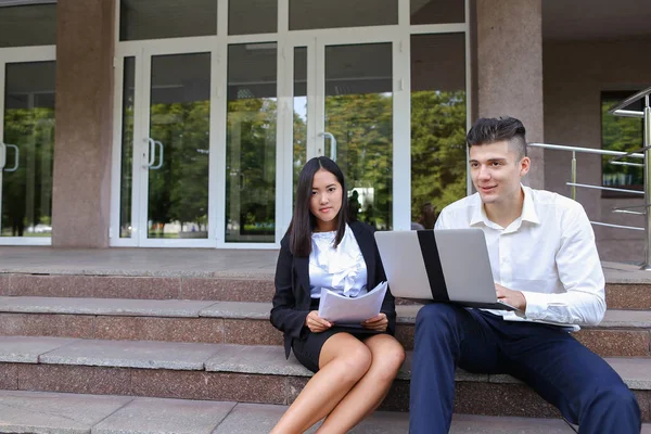 Attractive confident people, Caucasian boy and asian girl entrep