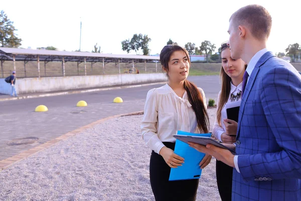 Three young successful businessman, students communicate, smilin