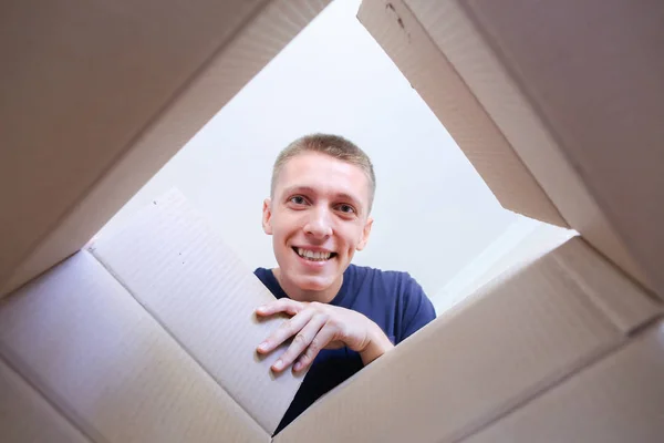 Male Opens Box Smiling And Stretching His Arms to Inside of Encl
