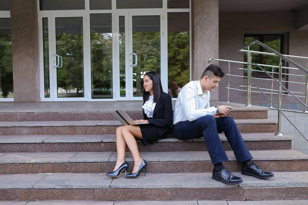 Attractive confident people, Caucasian boy and asian girl entrep