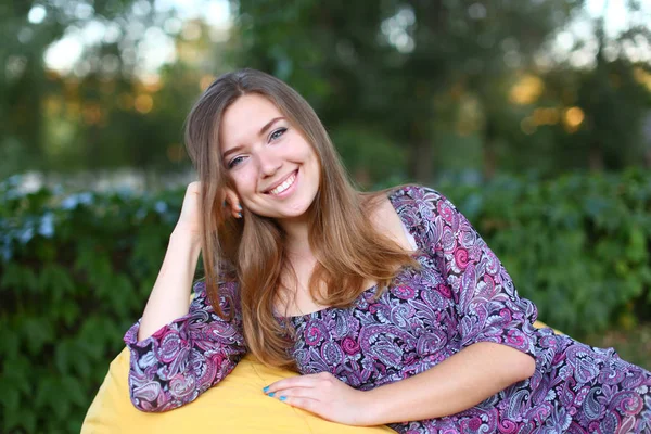 Ritratto di ragazza carina seduta sulla sedia e sorridente in fotografia — Foto Stock