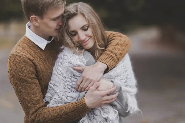 Portrait of beautiful young boyfriend hugs and gets warm girlfri — Stock Photo, Image