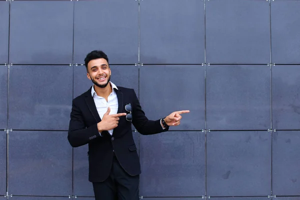 Árabe chico en negocios centro stands sonriendo caminar lento — Foto de Stock