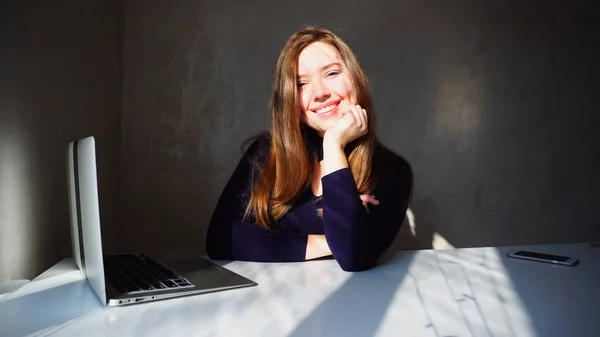 Retrato de hoyuelos chica joven con ordenador portátil, hermosa mujer sentada — Foto de Stock