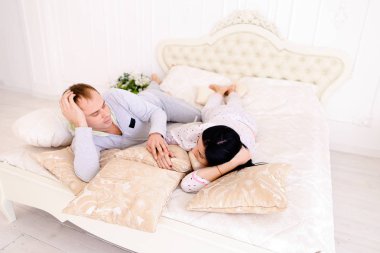 Sabahın erken saatlerinde bir beyaz odada yatakta sarılma karısı kocası