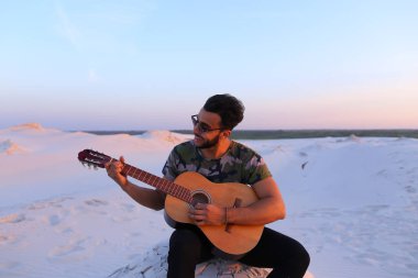 Çekici Arap adam gitar, Hill'de oturan şarkı söylüyor