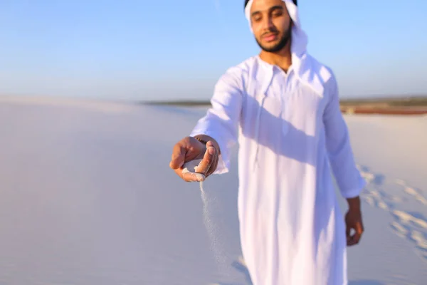 Close-up shot of portrait and hands of young Arab guy in sandy d — Stock Photo, Image