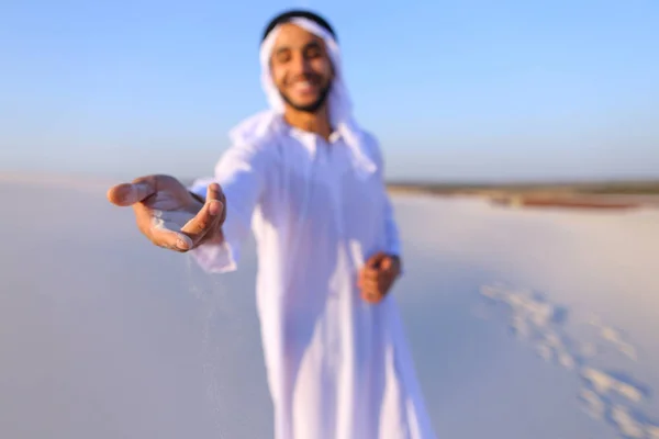 Close-up shot of portrait and hands of young Arab guy in sandy d — Stock Photo, Image