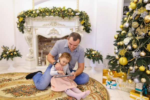 Bonito papai filha e papai jogar no tablet sentado no chão i — Fotografia de Stock