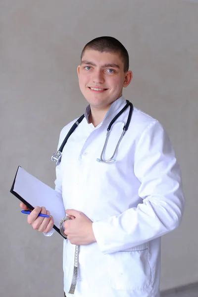 Professional male therapist looks at camera with smile and stand — Stock Photo, Image