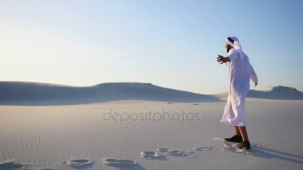 Feliz macho árabe Sheikh caminha ao longo do deserto de areia branca e se alegra no novo dia com dia de verão claro . — Vídeo de Stock