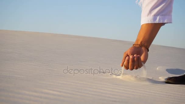 Close-up shot of portrait and hands of Muslim man in sandy desert on clear summer afternoon outdoors. — Stock Video