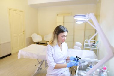 Profesyonel kadın microblading master araçları iş için hazırlar.