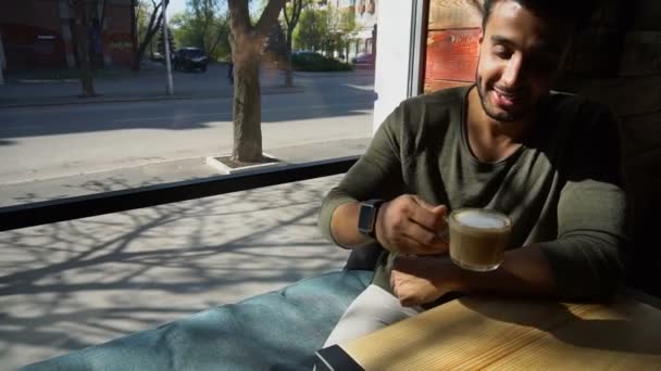 Arabian businessman waiting for partner and drinking coffee in slow motion. — Stock Video