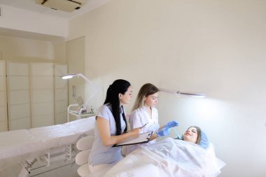 Kadın kaş dövme ana kız öğrenci c ile çalışmak için öğretir
