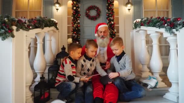 Satisfied kids enjoying  with presents from Santa Claus. — Stock Video