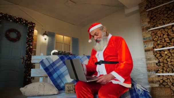 Jocund Pai Natal falando com vídeo por laptop . — Vídeo de Stock