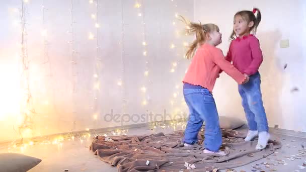 Two little girls kept for hands and fun dance. — Stock Video