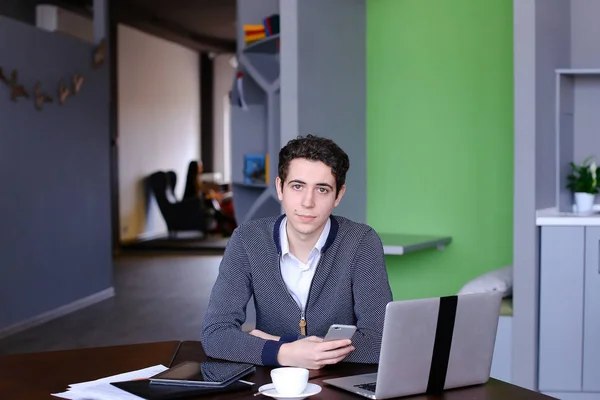 Portrait of smart young guy student who posing and looking in ca