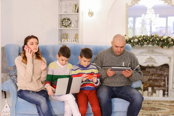 Modern and mobile family, two sons and husband and wife are busy