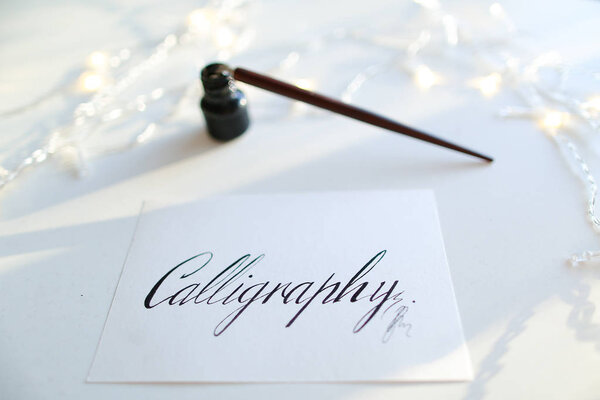 Beautiful postcard with calligraphic inscription of black ink on