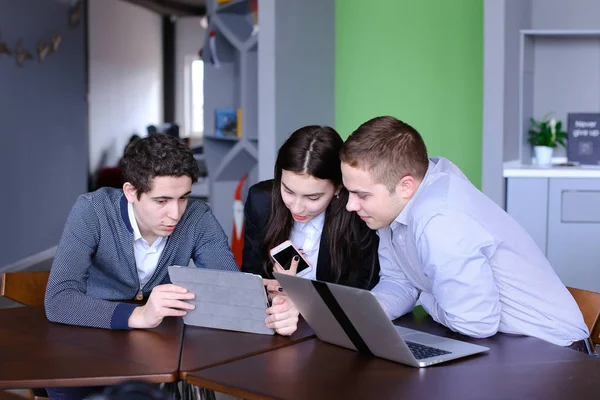 Három munkatársának, a nő és a két fiatal férfi ül a szociális háló — Stock Fotó