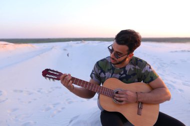 Arap yakışıklı genç gitar mi Hill'de oturan, ayarlar