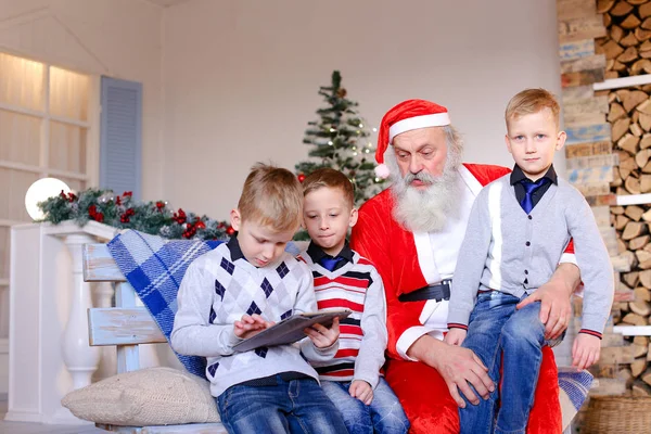 Meninos com Papai Noel brincando com tablet . — Fotografia de Stock