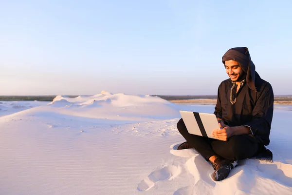 受过教育的阿拉伯学生使用笔记本电脑和工作坐在沙滩上 — 图库照片