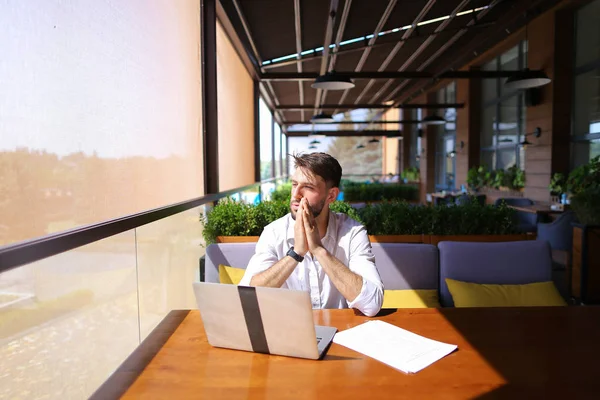 Caucasian realtor working with laptop and chatting with client o