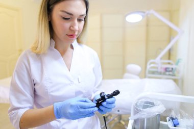 Profesyonel kadın microblading master araçları iş için hazırlar.