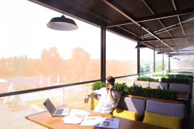 Smartphone ile konuşmak ve laptop ile çalışma emlakçı