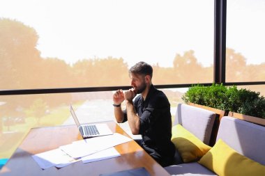 Miktar arazi kafeterya masada kağıtları ve dizüstü bilgisayar ile çalışma.