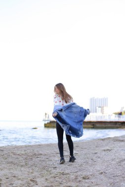 Sevimli kadın gülümseme ile teşkil etmektedir ve deniz kıyı savaş yürür