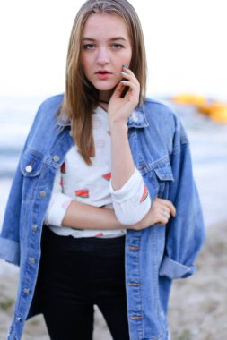 Sevimli kadın kamera, sahil sakin su üzerinde ayakta poz