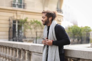 Genç erkek model smartphone ile sohbet ve müzik