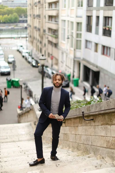 Guapo mezclar sangre hombre caminando por los escalones con periódico . — Foto de Stock