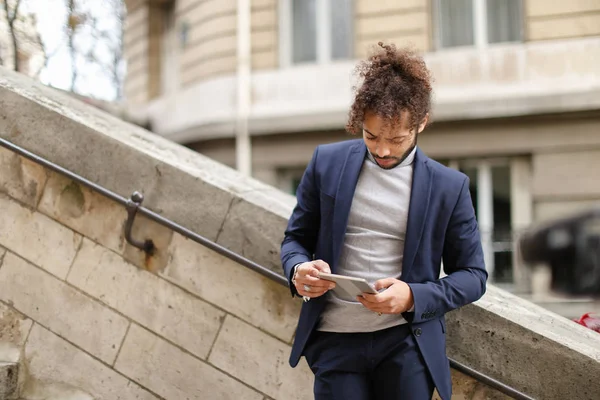 Close up face male person looking at camera with tablet.