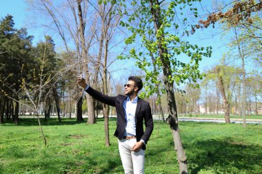 Ağır çekimde el Müslüman çocuk test yeni telefon ve gösteren barış işareti