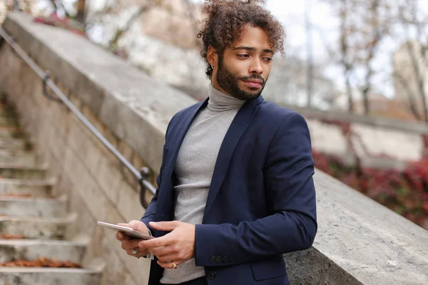 Close up face male person looking at camera with tablet.