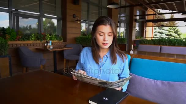 Beautiful lady reading menu at cafe in slow motion. — Stock Video