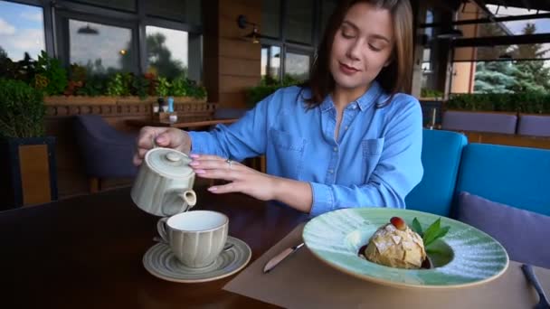 Чарівний клієнт ресторану вливає воду в чашку в повільному русі . — стокове відео