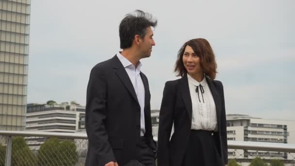 Slow motion economists male and female in strict suits walking. — Stock Video