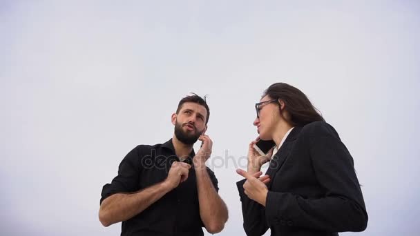 Teachers male and female talking on smartphones inviting colleagues to have rest in countryside — Stock Video