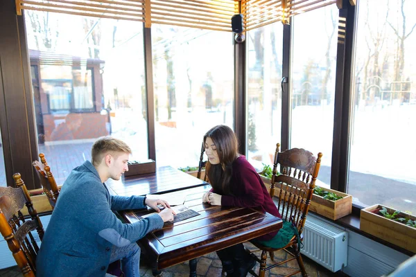 Lawyer discussing work with client at cafe