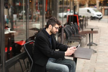 Online poker oyuncusu kafeterya masada tablet kullanma  .