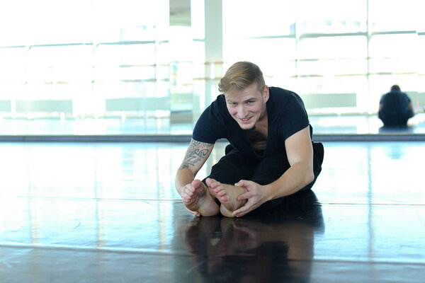 Man doing stretching in gym.