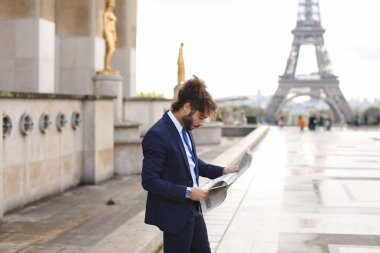 Melez pressman gazete makalesi Eiffel Tower yakınındaki okuma.
